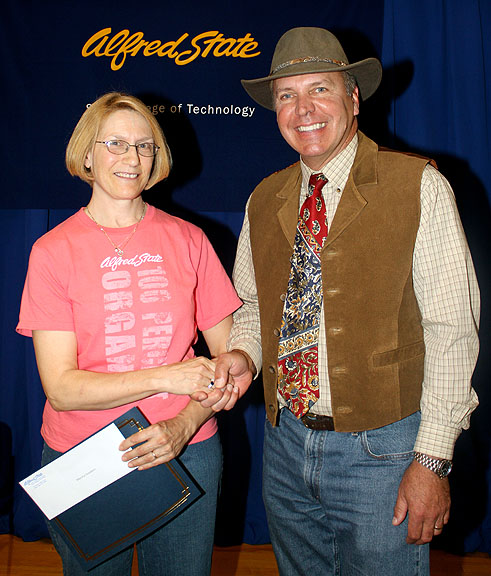 Alfred State College President Dr. John M. Anderson, right, congratulates Goodwin on her award. 